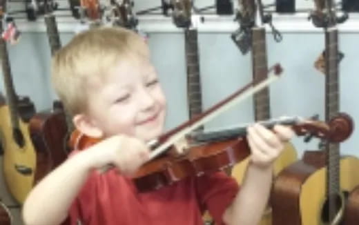 a boy holding a violin