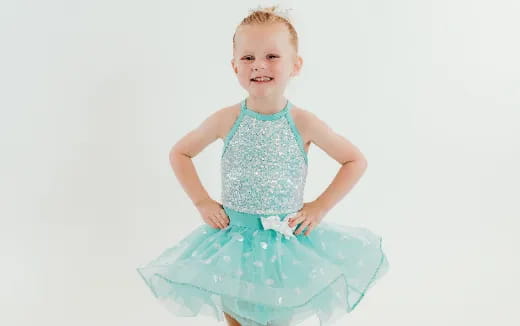 a baby in a blue dress