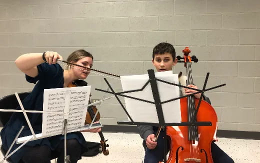 a man and a woman playing the violin