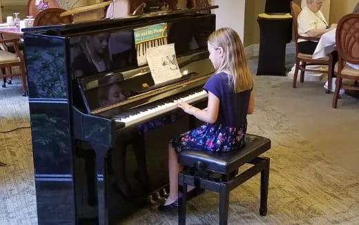 a girl playing a piano