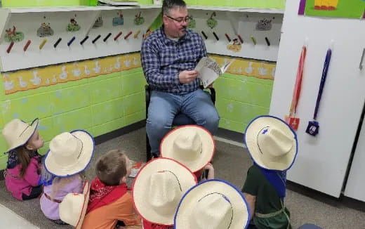 a man teaching children how to play drums