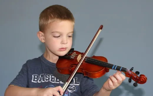 a boy playing a violin