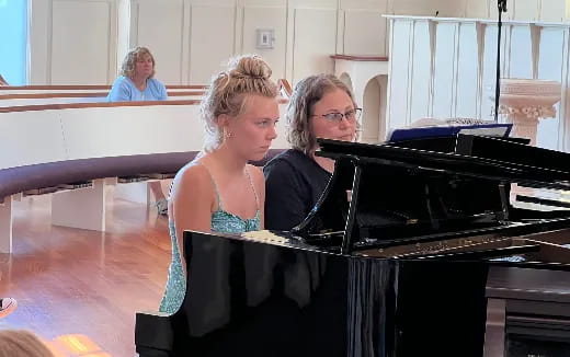 a group of people playing piano