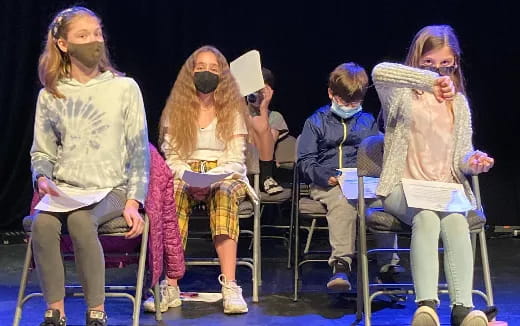 a group of people sitting on chairs