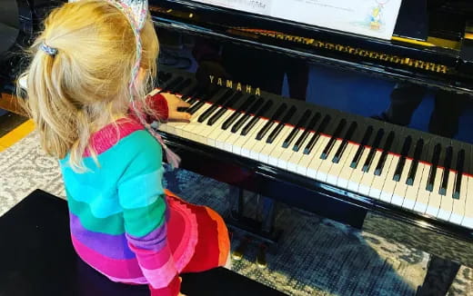 a girl playing a piano