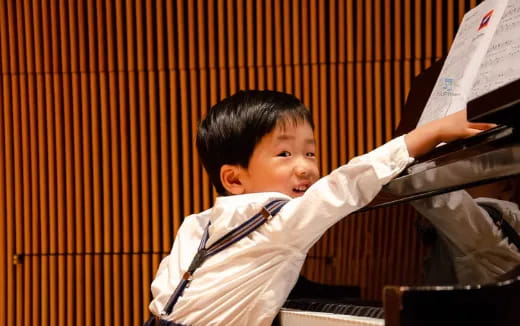 a boy playing piano