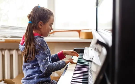 a girl playing a piano