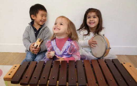 a group of kids playing with a drum