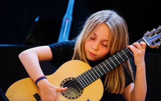 a girl playing a guitar