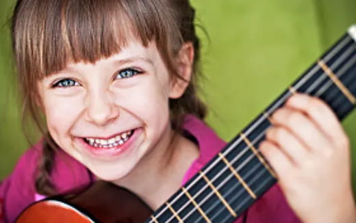 a girl playing a guitar