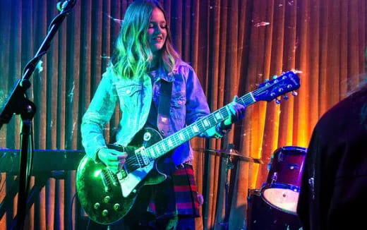 a woman playing a guitar