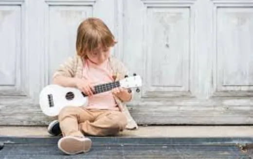 a child playing a guitar