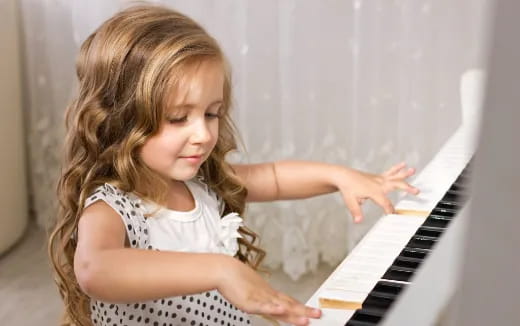 a girl playing a piano