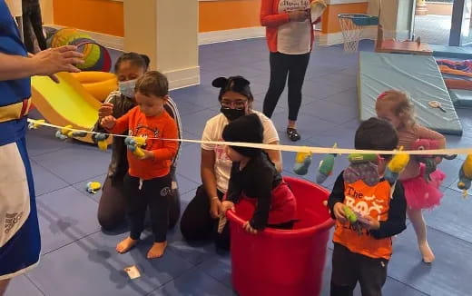a group of children playing in a pool