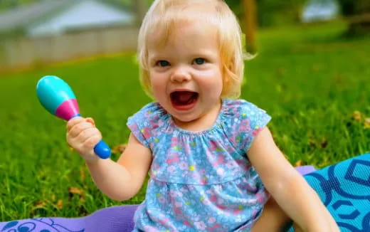 a baby holding a toy