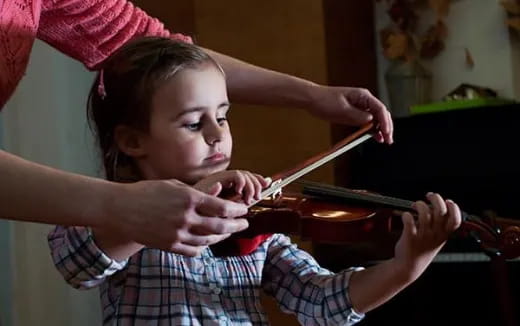 a girl playing a violin