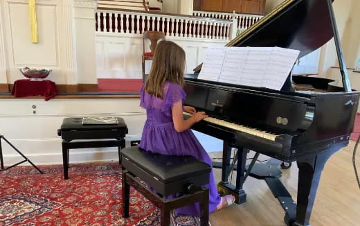 a girl playing the piano