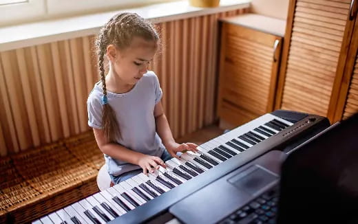 a girl playing a piano