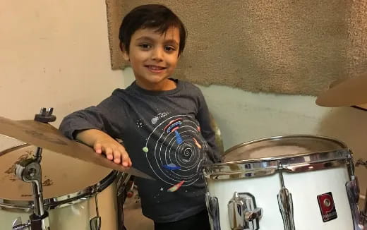 a boy playing drums