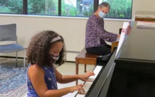 a girl playing a piano