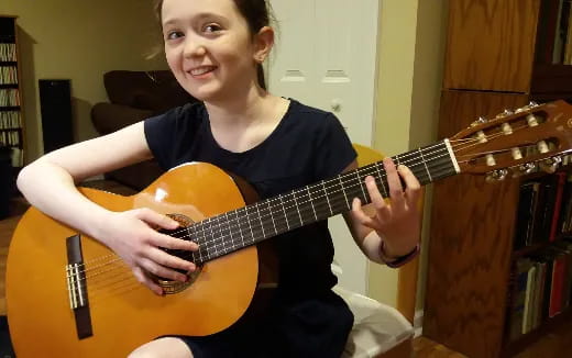 a girl playing a guitar