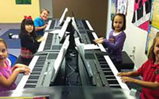 a group of people playing piano