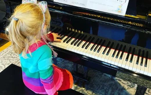 a girl playing a piano