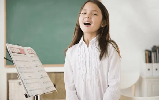 a girl holding a paper