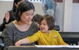 a person and a child looking at a book