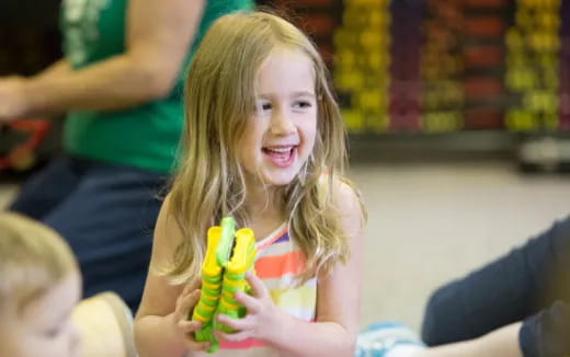 a girl holding a banana