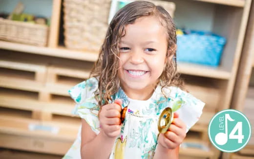 a girl holding a small toy