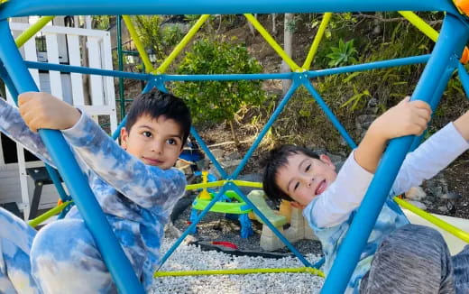 a couple of kids playing on a playground