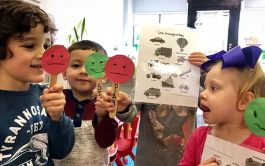 a group of children holding balloons