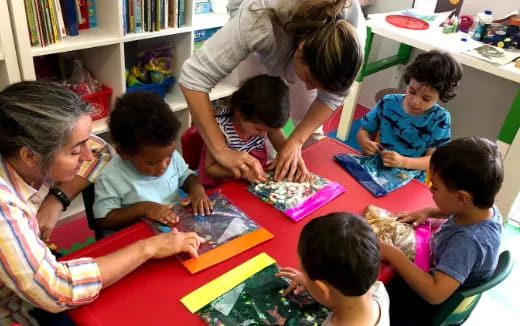 a group of children sitting around a table