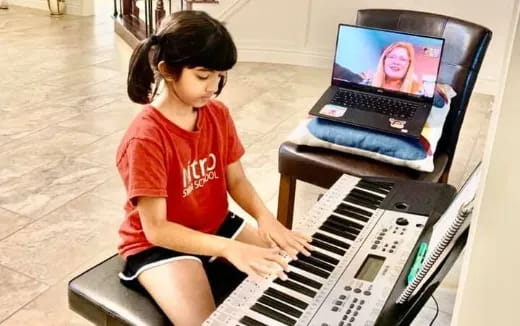 a girl playing a piano