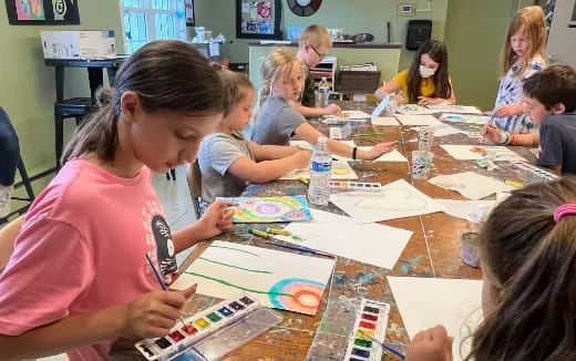 a group of children sitting at a table