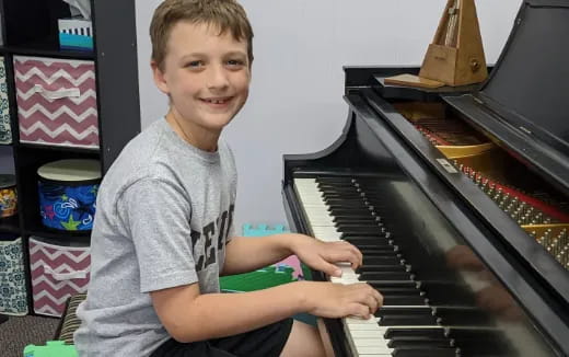 a boy playing a piano