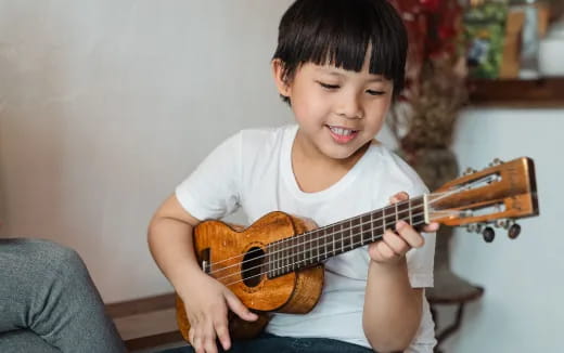 a boy playing a guitar