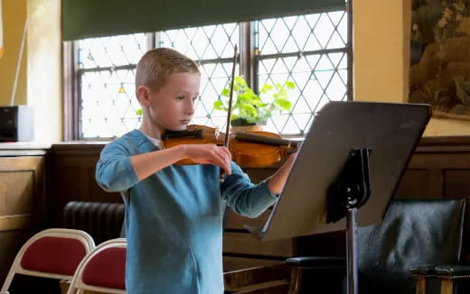 a boy playing a piano