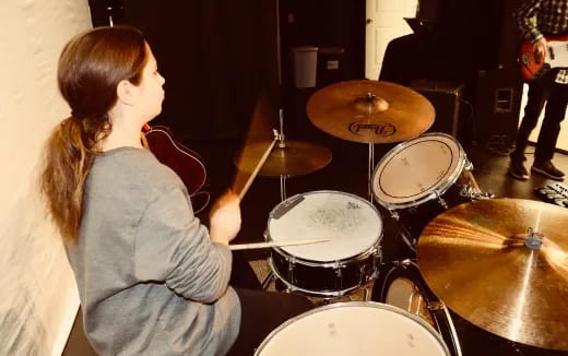 a girl playing the drums