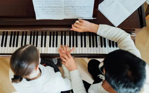 a few boys playing piano