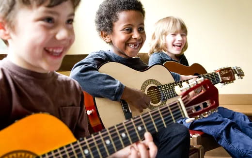 a group of kids playing guitars