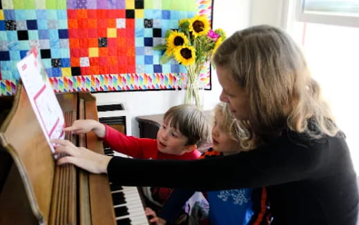 a person and a child playing piano