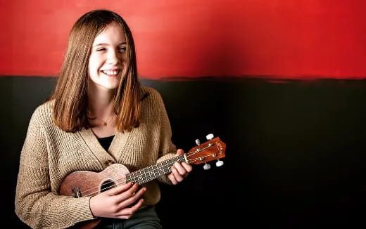 a woman playing a guitar