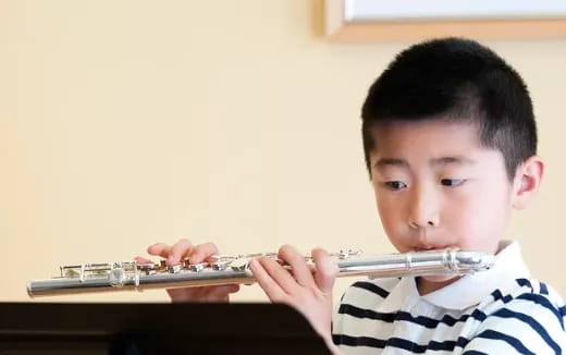 a boy playing a flute