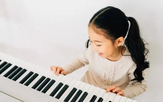 a baby playing a piano