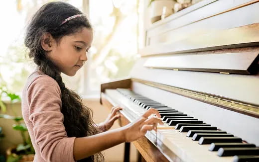 a girl playing a piano