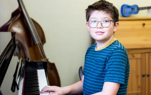 a boy holding a keyboard