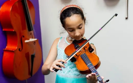 a girl playing a guitar