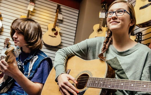 a man and a woman playing guitar